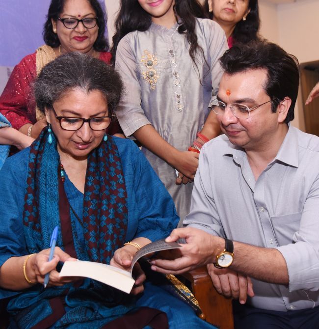 An author signing books and speaking with readers after a session