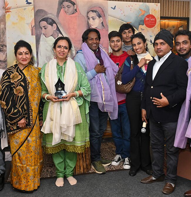 Panelists and organizers gathered on stage following the closing session