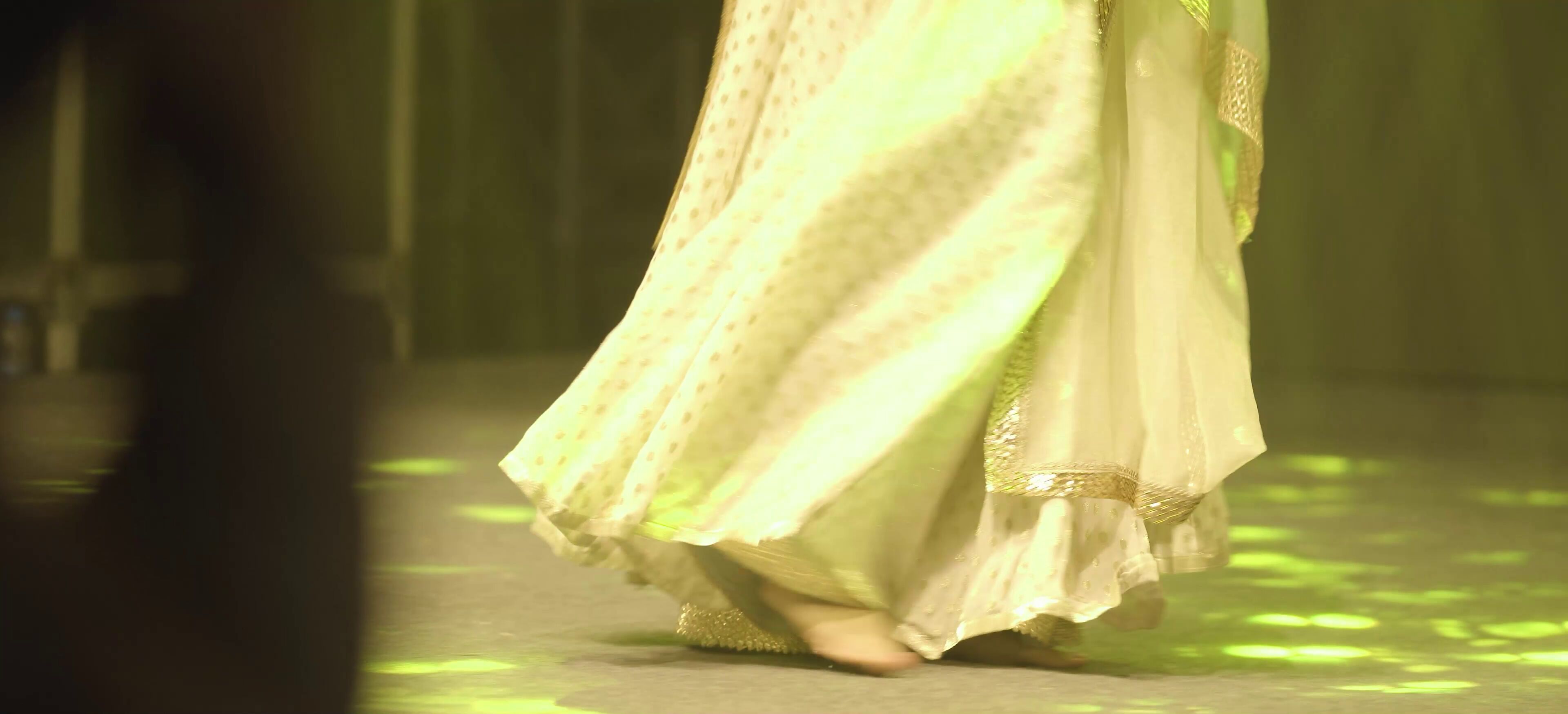 A Kathak dancer in a pirouette during a classical dance performance