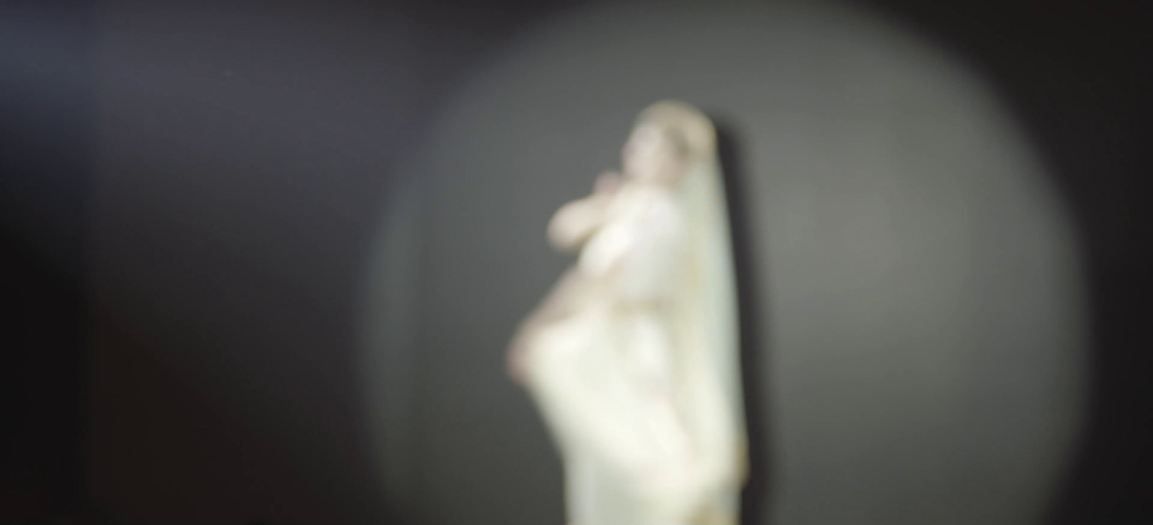 A classical dancer captured in the spotlight during an evening performance
