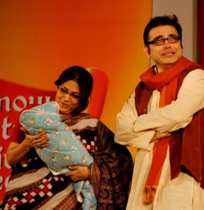 Speakers greeting each other warmly on stage at Gandhi Pratishthan